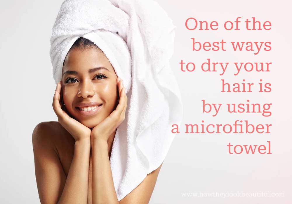 Woman drying hair using towel