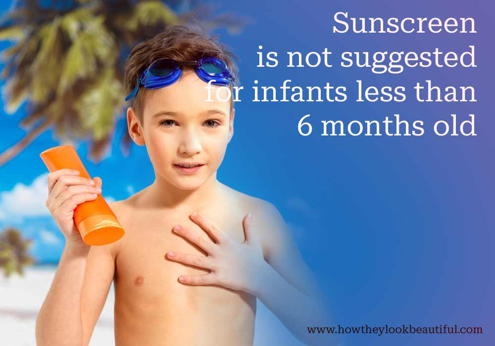 Child applying sunscreen on beach